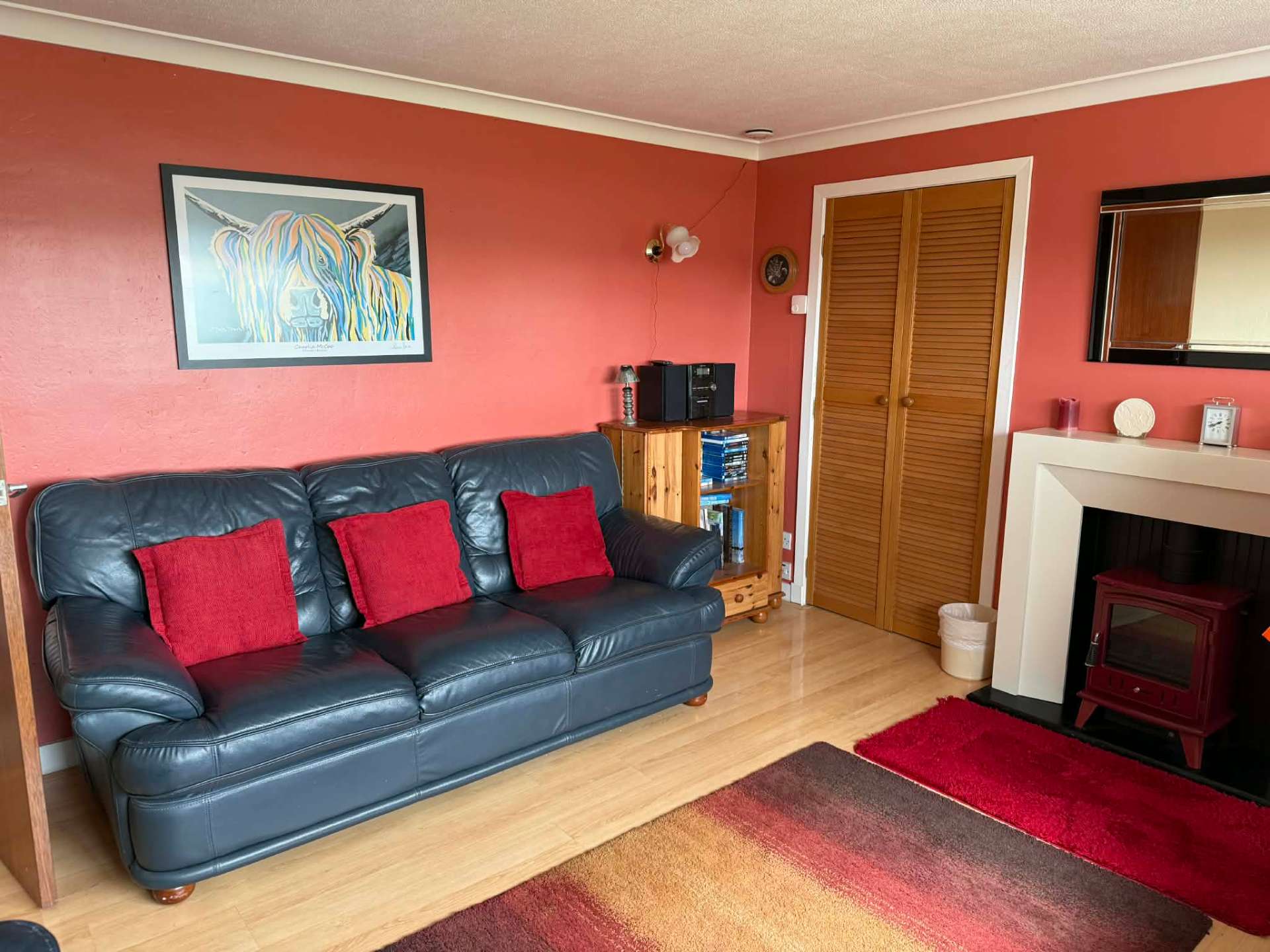 Cosy living room with leather sofas and stove